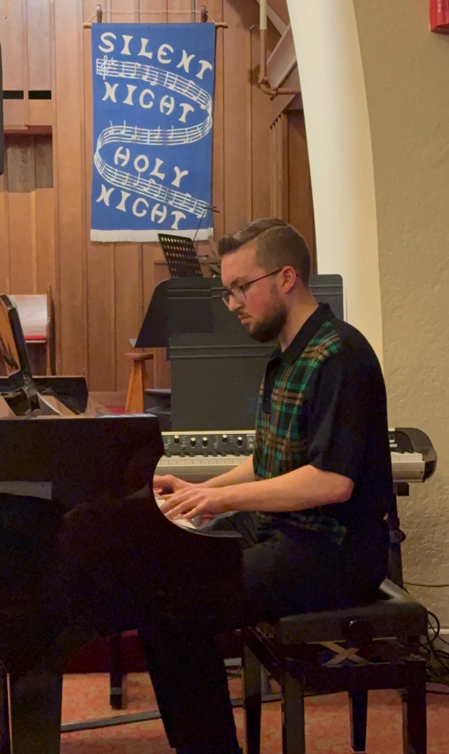 Andy playing a grand piano.